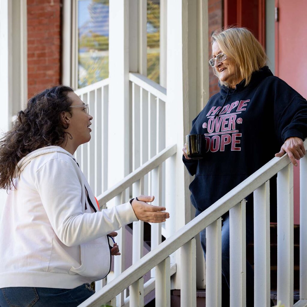 Two Saint Leonard's community members talking on steps